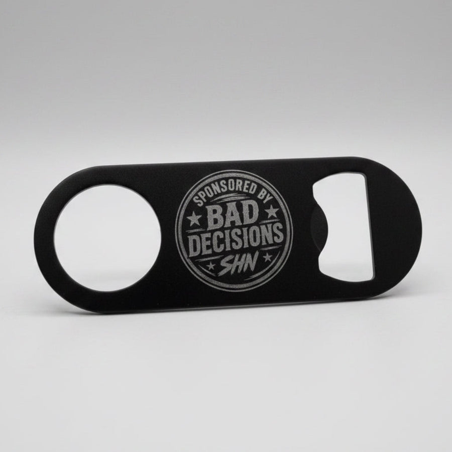 A black bottle opener with a circular 'Spotted by Bad Decisions SHN' logo